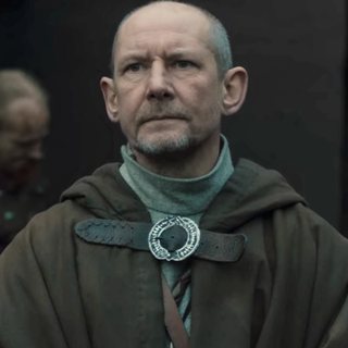 Father Beocca as seen in the show, played by Ian Hart